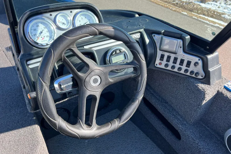 Slide: The Image of 2020 Lund 1675 Adventure Sport boat dashboard with steering wheel and control panel. - 19
