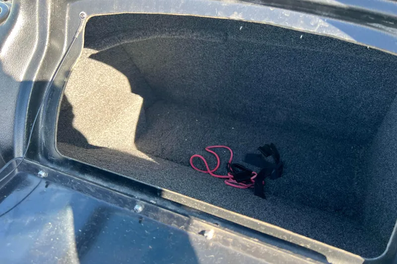 Slide: The Image of Storage compartment of 2020 Lund 1675 Adventure Sport boat with red and black cords. - 21