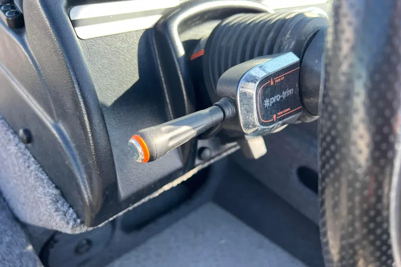 Slide: The Image of Close-up of 2020 Lund 1675 Adventure Sport boat control panel with Pro-Trim switch. - 23