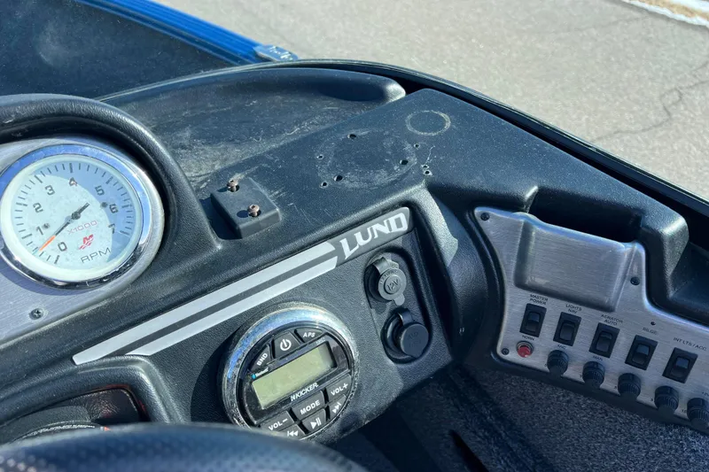 Slide: The Image of Dashboard of a 2020 Lund 1675 Adventure Sport boat with controls and RPM gauge. - 25