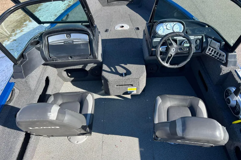 Slide: The Image of 2020 Lund 1675 Adventure Sport boat interior with steering wheel and seating. - 31