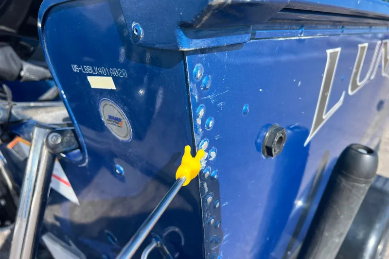 Slide: The Image of Close-up of a 2020 Lund 1675 Adventure Sport boat's blue exterior with rivets and a yellow tool. - 38