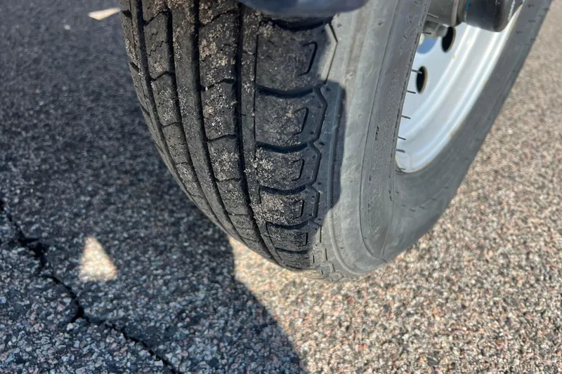 Slide: The Image of Close-up of a 2020 Lund 1675 Adventure Sport trailer tire on asphalt. - 40