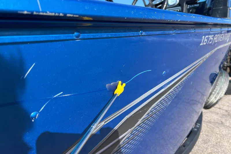 Slide: The Image of Blue 2020 Lund 1675 Adventure Sport boat with visible scratches and a yellow marker. - 41