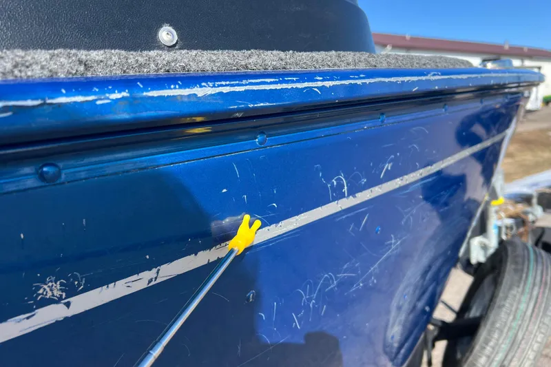 Slide: The Image of 2020 Lund 1675 Adventure Sport boat with visible scratches on blue hull. - 44