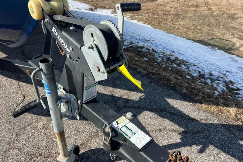 Slide: The Image of Trailer hitch and winch of a 2020 Lund 1675 Adventure Sport boat on pavement. - 51