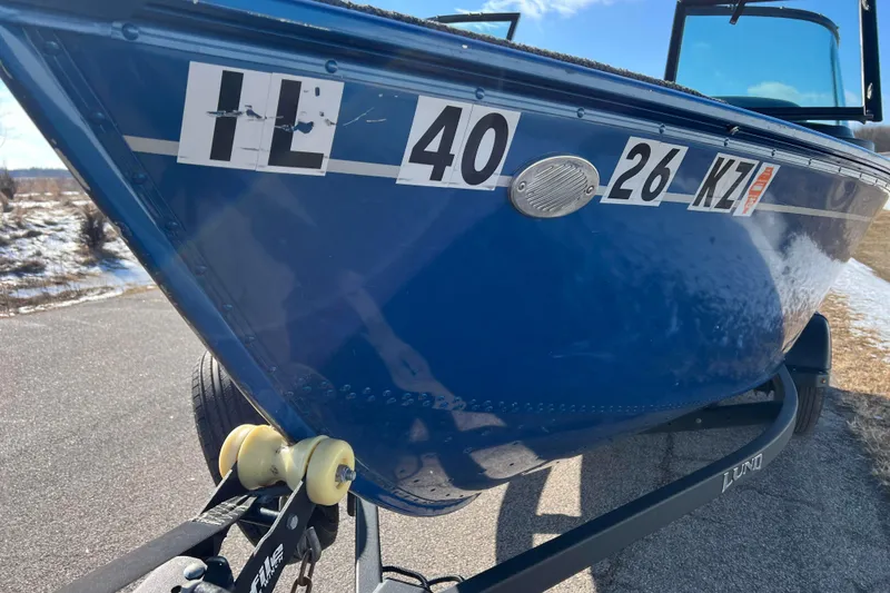 Slide: The Image of 2020 Lund 1675 Adventure Sport boat on trailer, blue hull with registration numbers. - 52