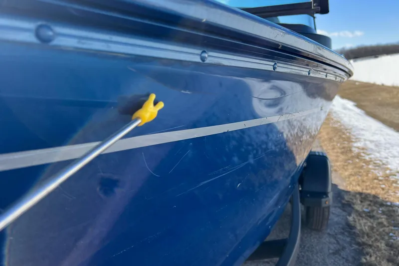 Slide: The Image of 2020 Lund 1675 Adventure Sport boat with a small dent on the blue hull. - 54