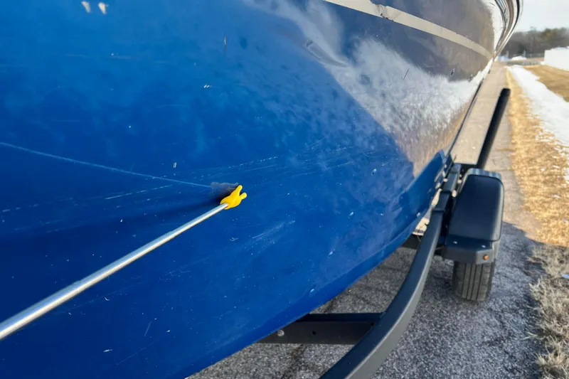 Slide: The Image of 2020 Lund 1675 Adventure Sport boat on trailer, close-up of blue hull with scratch. - 55