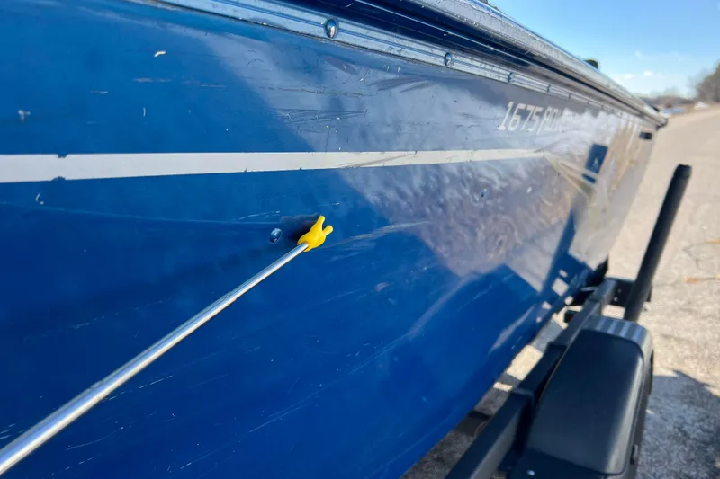 Slide: The Image of 2020 Lund 1675 Adventure Sport boat with blue hull and visible scratch. - 57