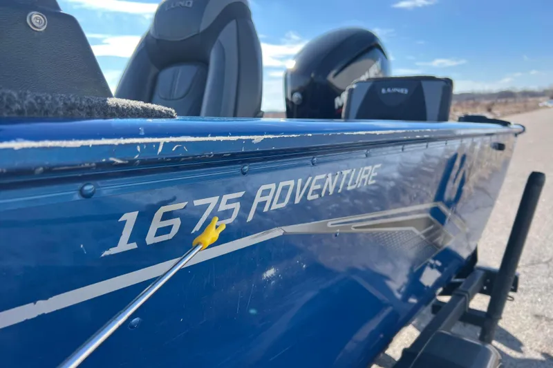Slide: The Image of 2020 Lund 1675 Adventure Sport boat, blue exterior with visible branding and seating. - 58