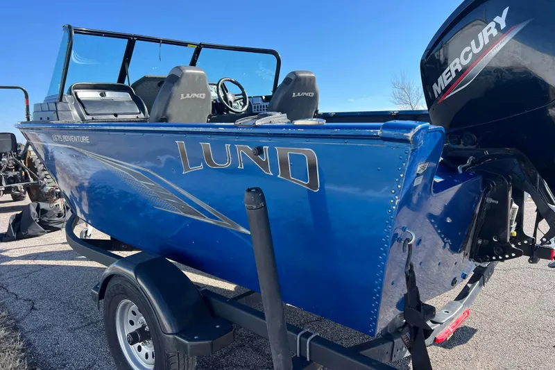 Slide: The Image of 2020 Lund 1675 Adventure Sport boat with Mercury engine, blue exterior, parked on trailer. - 6