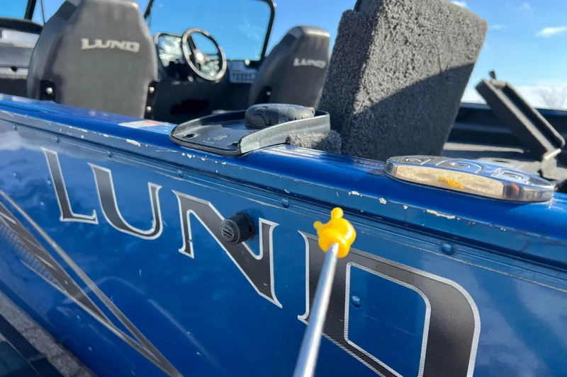 Slide: The Image of 2020 Lund 1675 Adventure Sport boat interior with logo and steering wheel visible. - 61