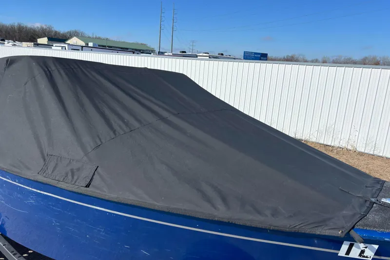 Slide: The Image of 2020 Lund 1675 Adventure Sport boat covered with a black tarp, parked outdoors. - 8