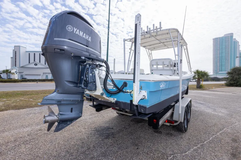 Slide: The Image of 2017 Andros Tarpon 26 boat with Yamaha engine on trailer, parked near buildings. - 13