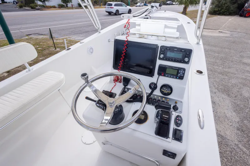 Slide: The Image of 2017 Andros Tarpon 26 boat cockpit with steering wheel and navigation controls. - 15