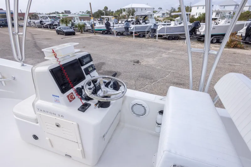 Slide: The Image of 2017 Andros Tarpon 26 boat console with steering wheel and navigation equipment. - 16