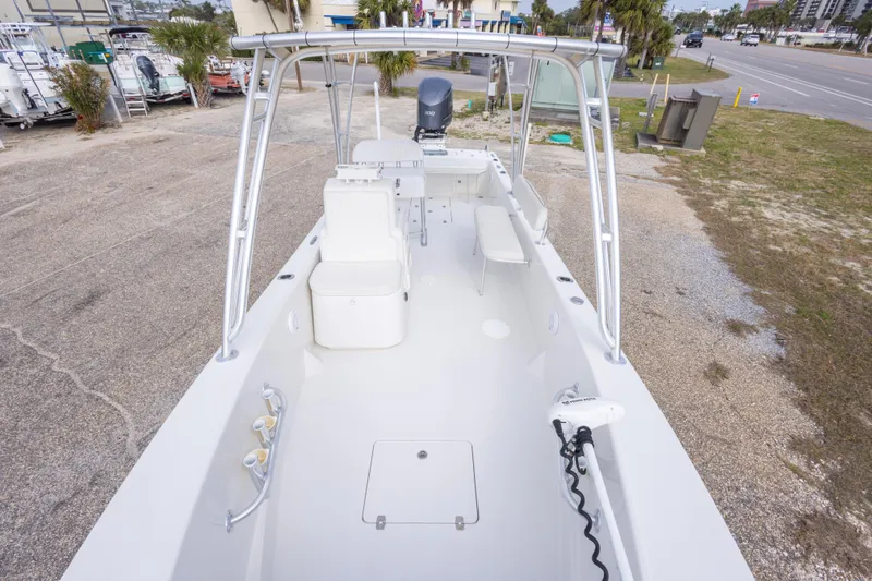 Slide: The Image of 2017 Andros Tarpon 26 boat with spacious deck and seating, parked outdoors. - 21
