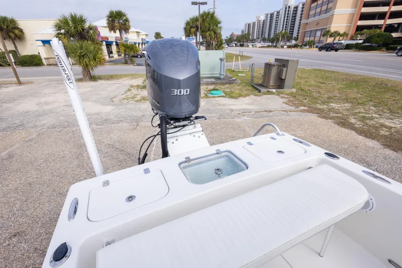 Slide: The Image of 2017 Andros Tarpon 26 boat with 300 HP engine, parked near buildings and palm trees. - 24