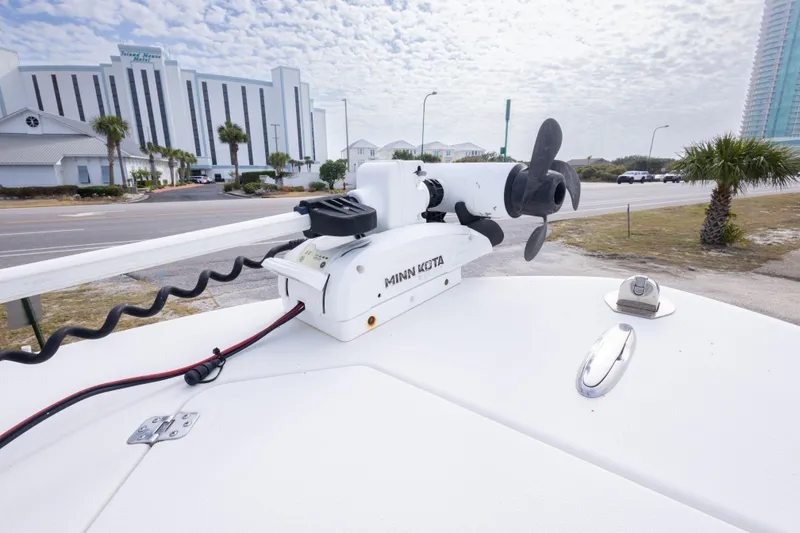 Slide: The Image of 2017 Andros Tarpon 26 boat with Minn Kota trolling motor, coastal background. - 28