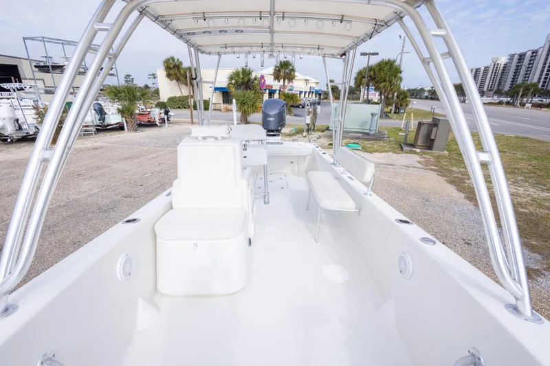 Slide: The Image of 2017 Andros Tarpon 26 boat with spacious deck and seating, parked outdoors. - 29