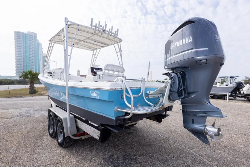 Slide: The Image of 2017 Andros Tarpon 26 boat with Yamaha engine on trailer, coastal background. - 33
