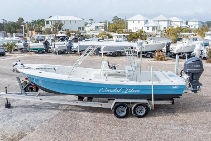 Slide: The Image of 2017 Andros Tarpon 26 boat on trailer, labeled "Coastal Blues," with Yamaha engine. - 6