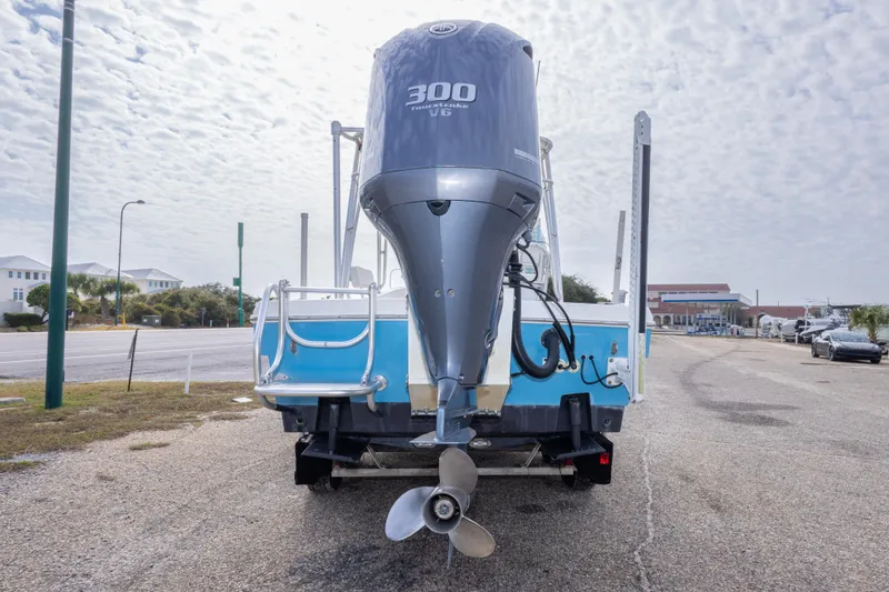 Slide: The Image of 2017 Andros Tarpon 26 boat with 300 horsepower engine, parked on a coastal road. - 14