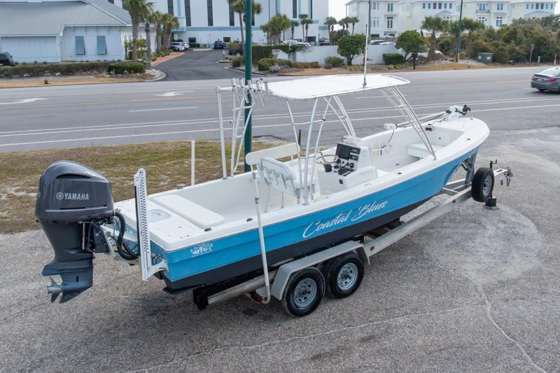 Slide: The Image of 2017 Andros Tarpon 26 boat on trailer with Yamaha engine, parked near road. - 5