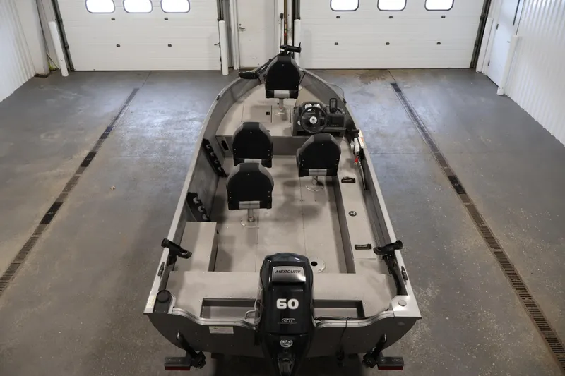 Slide: The Image of 2019 Crestliner 1800 Kodiak SC boat in a garage, featuring a Mercury 60 engine. - 10
