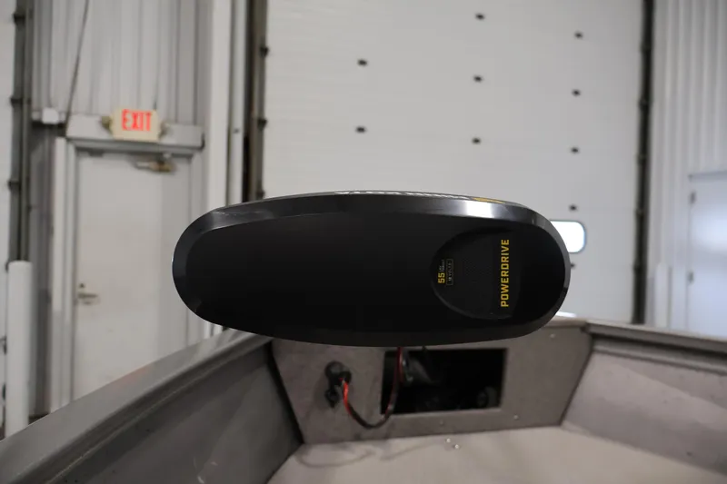 Slide: The Image of 2019 Crestliner 1800 Kodiak SC boat with PowerDrive motor in a garage setting. - 12