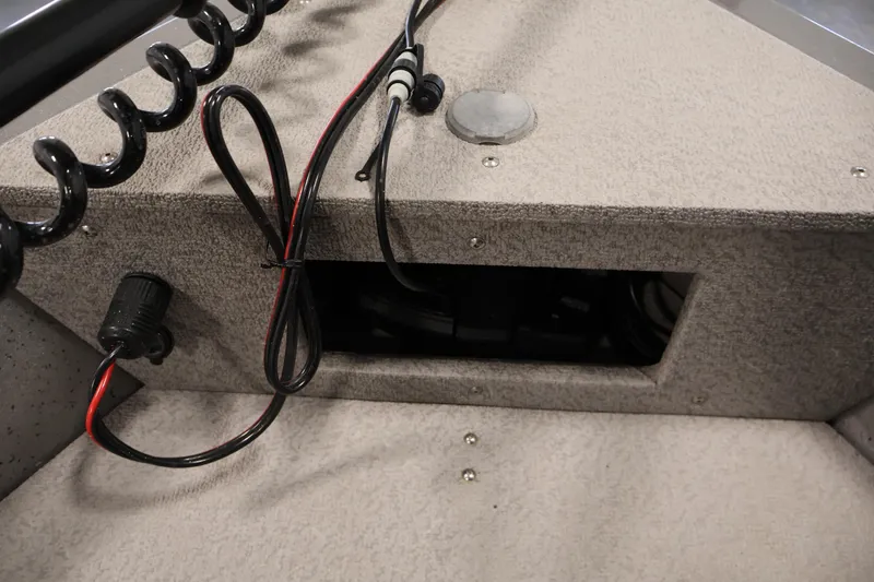 Slide: The Image of Interior view of 2019 Crestliner 1800 Kodiak SC boat showing wiring and storage compartment. - 15