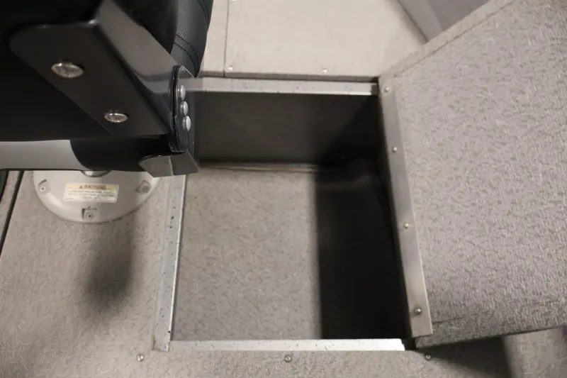 Slide: The Image of 2019 Crestliner 1800 Kodiak SC boat storage compartment with gray carpeted interior. - 21
