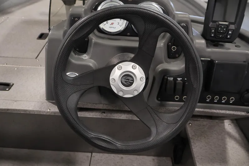 Slide: The Image of Steering wheel of 2019 Crestliner 1800 Kodiak SC boat with dashboard controls. - 25