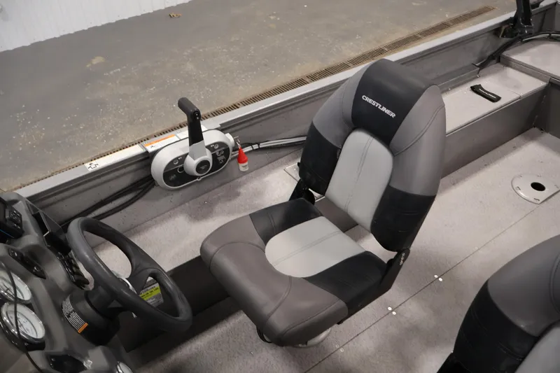 Slide: The Image of 2019 Crestliner 1800 Kodiak SC boat interior with steering wheel and seat. - 32