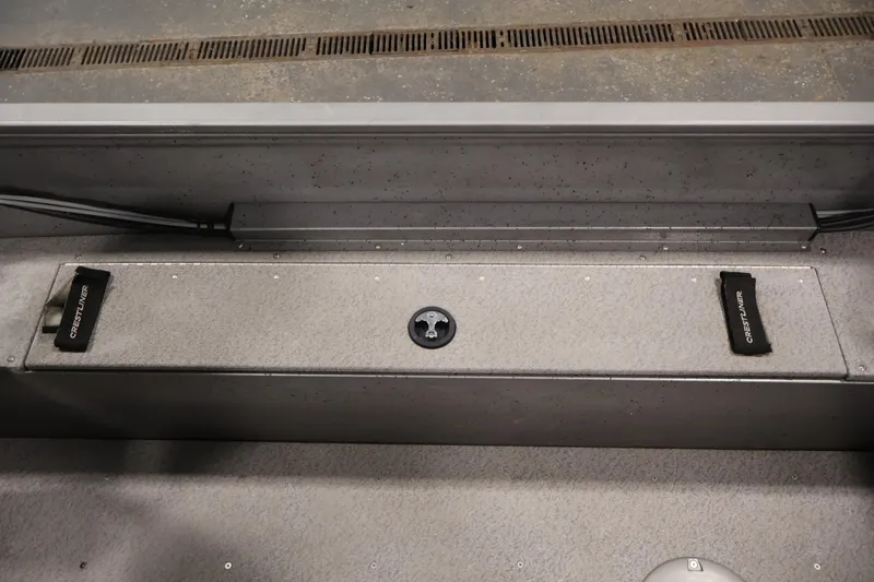 Slide: The Image of 2019 Crestliner 1800 Kodiak SC boat interior with storage compartment and Crestliner branding. - 35