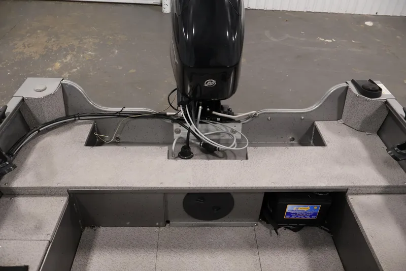 Slide: The Image of 2019 Crestliner 1800 Kodiak SC boat interior with motor and battery compartment. - 37