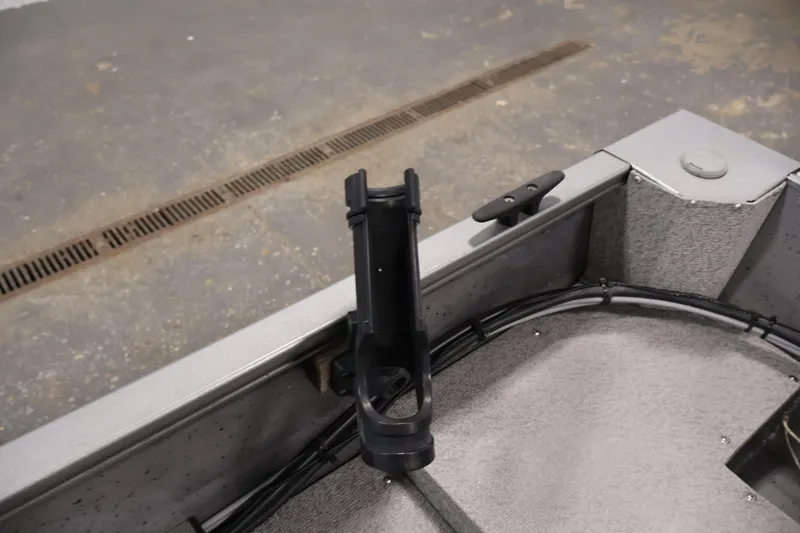 Slide: The Image of 2019 Crestliner 1800 Kodiak SC boat interior with rod holder and cleat. - 38