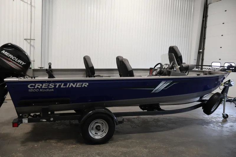 Slide: The Image of 2019 Crestliner 1800 Kodiak SC fishing boat with Mercury outboard in a garage. - 4