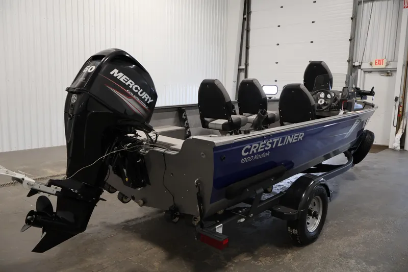 Slide: The Image of 2019 Crestliner 1800 Kodiak SC boat with Mercury outboard motor in a garage setting. - 5
