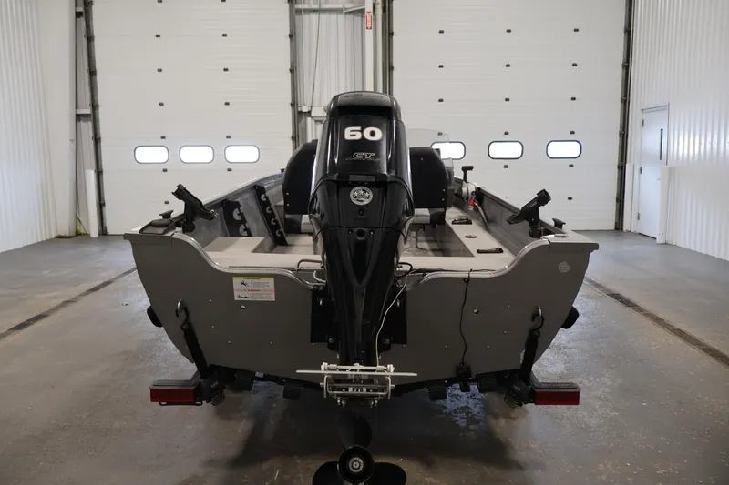 Slide: The Image of 2019 Crestliner 1800 Kodiak SC boat with 60 HP motor in a garage setting. - 6