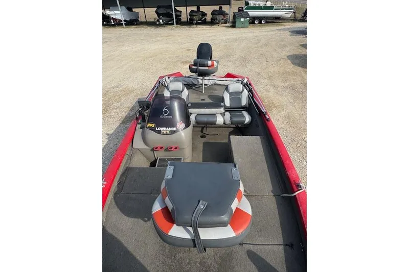 Slide: The Image of 2005 Tracker Pro Team 175 boat interior with seating and equipment, parked on gravel. - 10