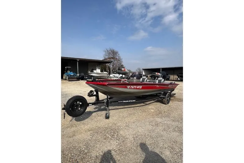 Slide: The Image of 2005 Tracker Pro Team 175 boat on trailer, parked outdoors under blue sky. - 2
