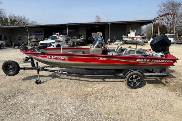 Slide: The Image of 2005 Tracker Pro Team 175 bass boat on trailer, parked outdoors. - 3