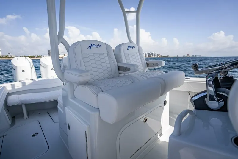 Slide: The Image of 2025 Yellowfin 34 Offshore boat interior with luxurious seating and ocean view. - 14