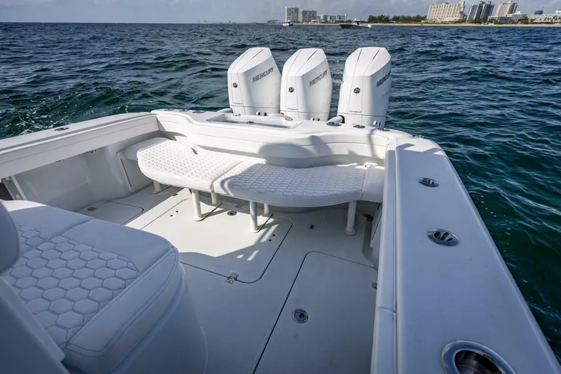 Slide: The Image of 2025 Yellowfin 34 Offshore boat interior with triple Mercury engines on open water. - 18