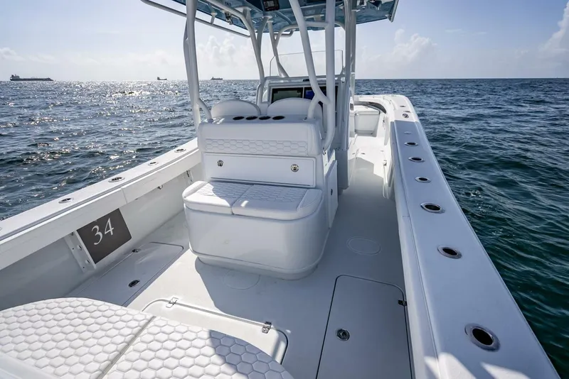 Slide: The Image of 2025 Yellowfin 34 Offshore boat on open water, showcasing spacious deck and seating. - 27