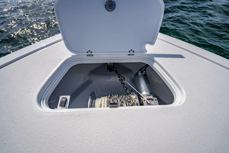 Slide: The Image of Open anchor locker on 2025 Yellowfin 34 Offshore boat, showing chain and winch mechanism. - 35