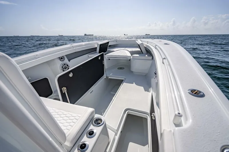 Slide: The Image of 2025 Yellowfin 34 Offshore boat interior with open storage, on calm ocean waters. - 37