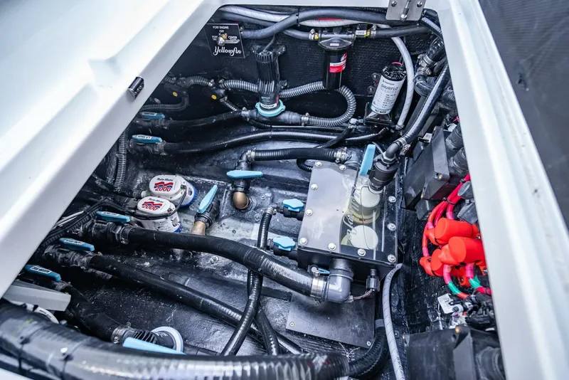 Slide: The Image of Engine compartment of 2025 Yellowfin 34 Offshore boat, showcasing wiring and components. - 38